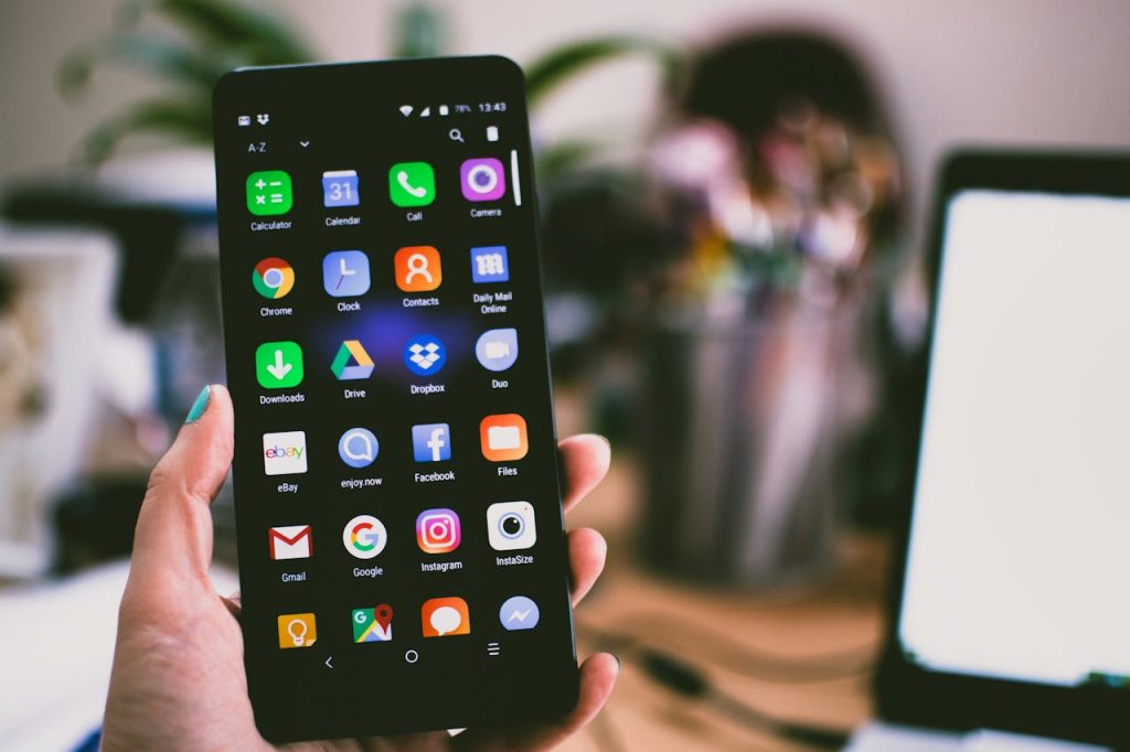 image-of-a-female-hand-holding-a-phone-showing-apps-selective-focus-photo-by-lisa-fotios