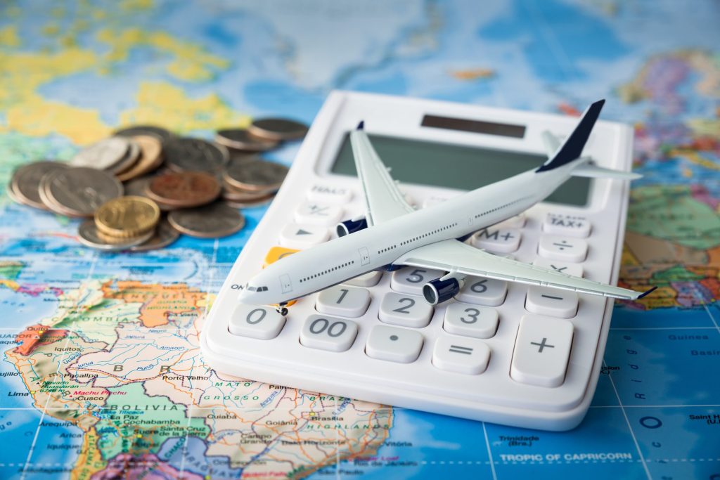 istock-image-of-collage-of-calculator-on-a-map-to-signify-cost-of-travel